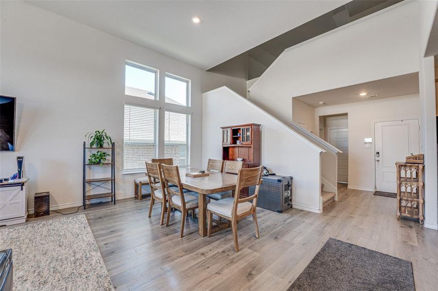 Dining space with light wood-type flooring, stairs, and recessed lighting