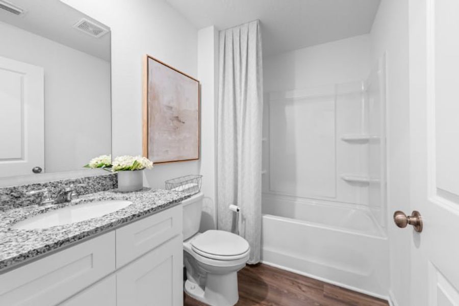 A bathroom with a tub sink and toilet. A bathroom with a tub sink and toilet.