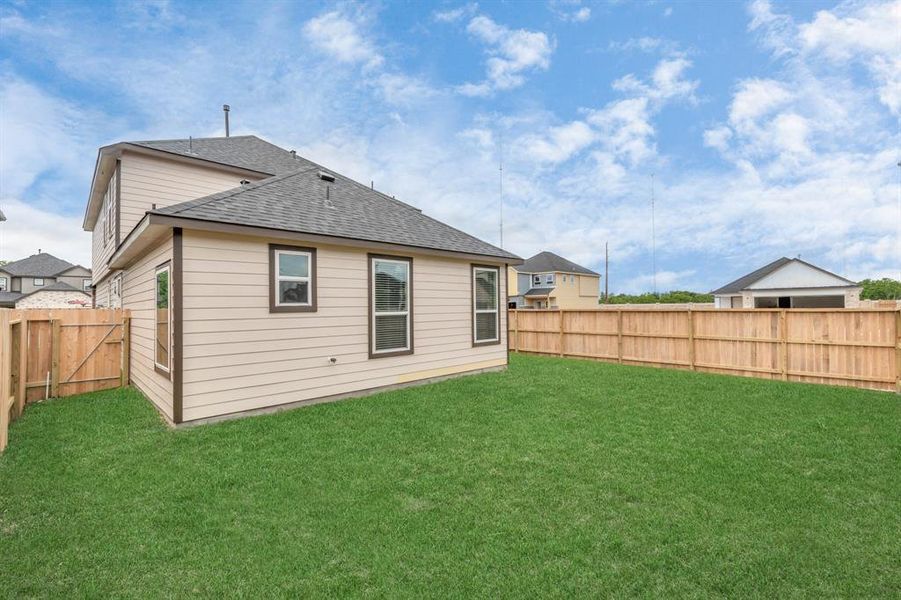 Step into a world of outdoor possibilities with this remarkable backyard and its charming covered patio. From playtime for the kids to relaxation for the adults, this space offers the best of both worlds. Customize it with patio furniture, a BBQ pit, and more, turning it into the ultimate outdoor retreat that suits your lifestyle