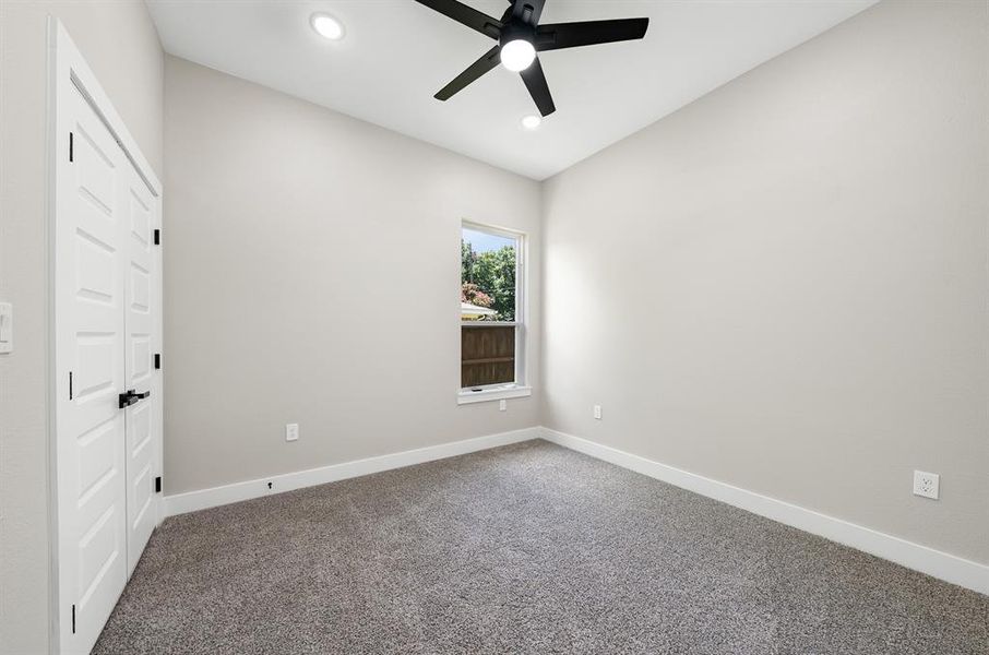 Carpeted 2nd Bedroom with a ceiling fan and recessed lighting Carpeted 2nd Bedroom with a ceiling fan and recessed lighting