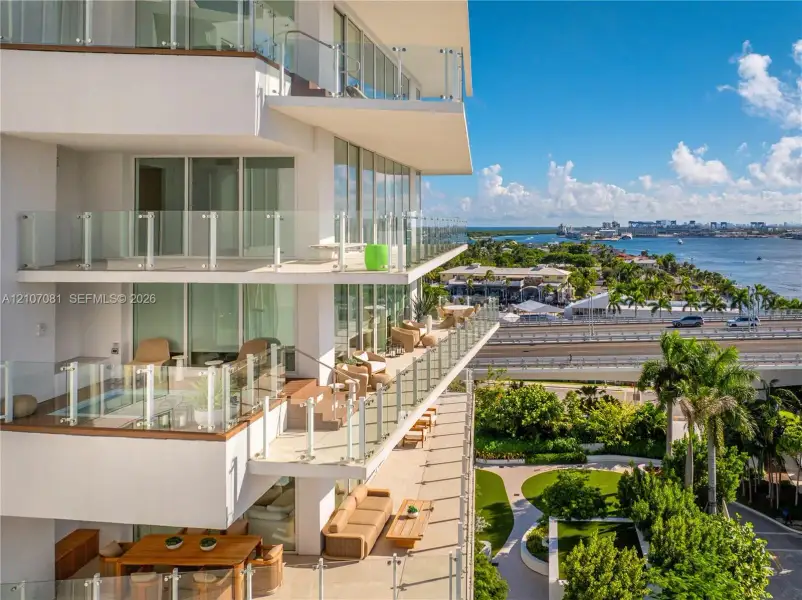 Multi-level exterior balconies featuring glass railings and floor-to-ceiling windows Multi-level exterior balconies featuring glass railings and floor-to-ceiling windows