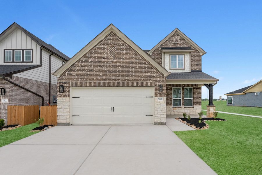 Front exterior of a new home in Grand Mason Crossing, Katy, TX, highlighting curb appeal (Image 2). Front exterior of a new home in Grand Mason Crossing, Katy, TX, highlighting curb appeal (Image 2).