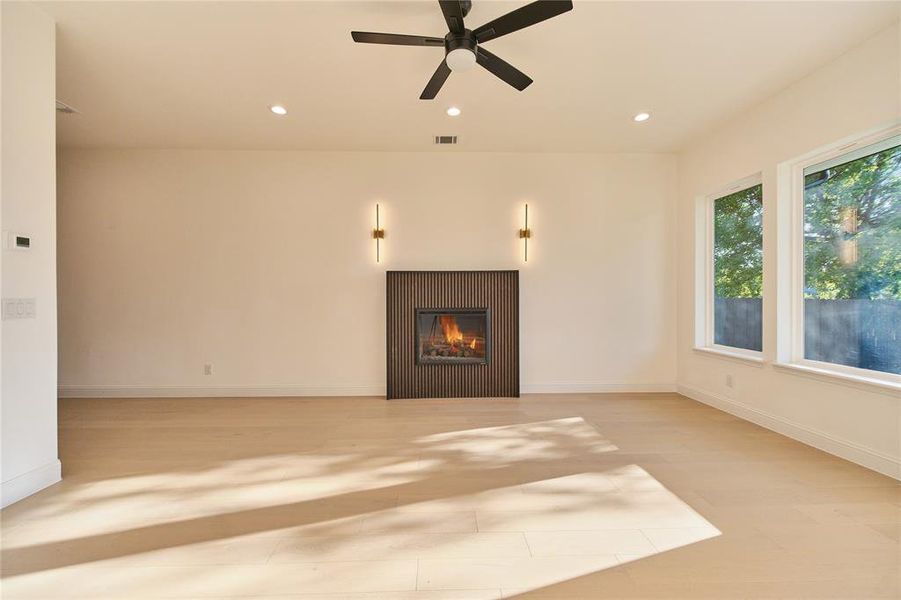 Unfurnished living room with ceiling fan