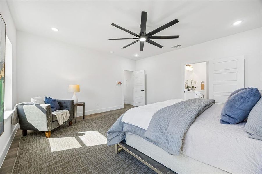 The primary bedroom is large enough for a sitting area