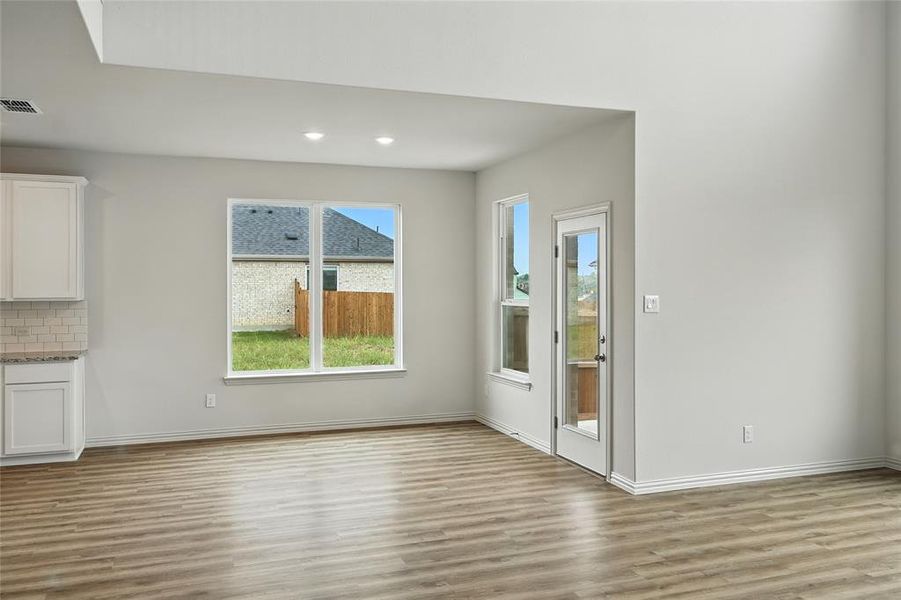Unfurnished dining area featuring light wood-style flooring and recessed lighting Unfurnished dining area featuring light wood-style flooring and recessed lighting