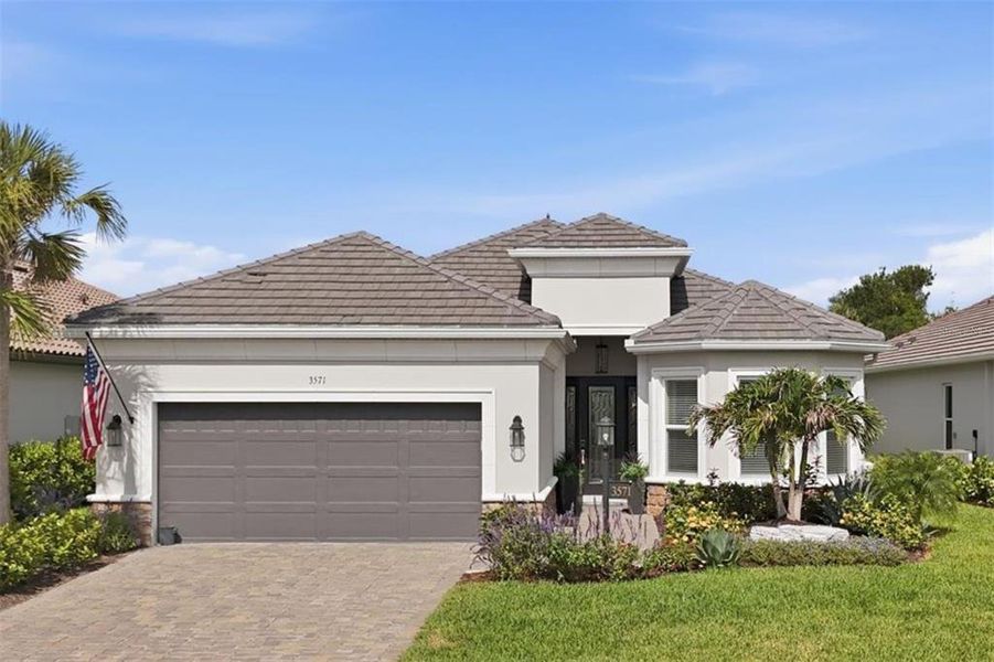 Front exterior of a new home in Esplanade at Azario Lakewood Ranch, Bradenton, FL, highlighting curb appeal (Image 22).