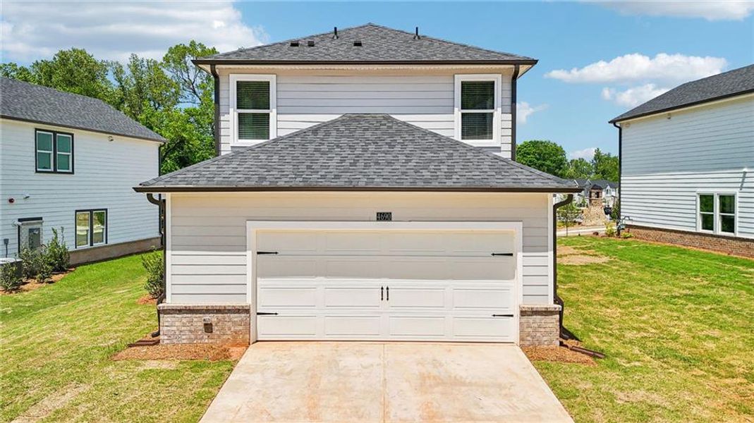 Front exterior of a new home in Hemingway - Cottage Series, Cumming, GA, highlighting curb appeal (Image 1). Front exterior of a new home in Hemingway - Cottage Series, Cumming, GA, highlighting curb appeal (Image 1).
