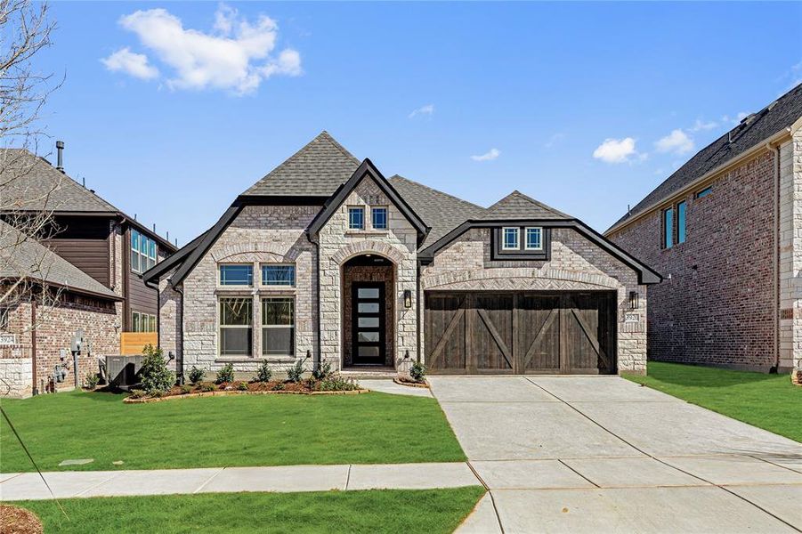 Front exterior of a new home in Painted Tree Woodland District 50, McKinney, TX, highlighting curb appeal (Image 23).