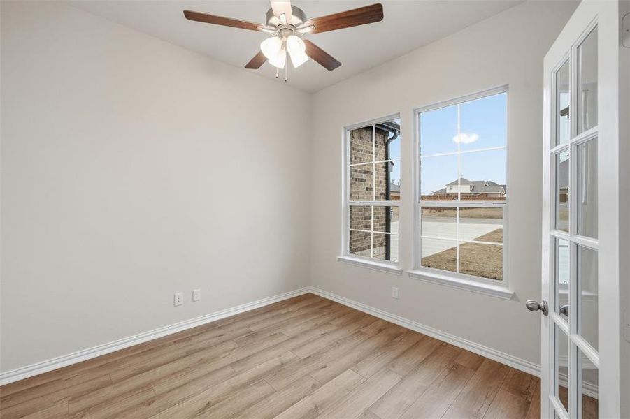 Empty room with light wood-style flooring and ceiling fan Empty room with light wood-style flooring and ceiling fan