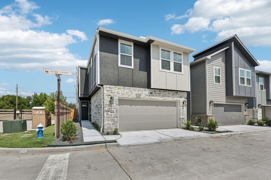 Front exterior of a new home in Spring Brook Village - City Series, Houston, TX, highlighting curb appeal (Image 2). Front exterior of a new home in Spring Brook Village - City Series, Houston, TX, highlighting curb appeal (Image 2).