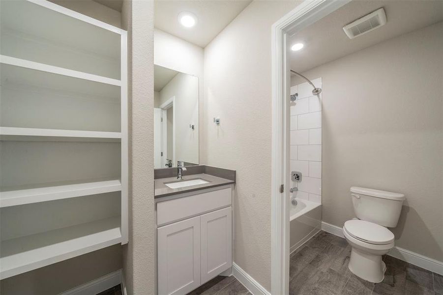 Full bathroom in the hallway for secondary bedrooms and guests.  Has separate door to give privacy to shower/tub and toilet