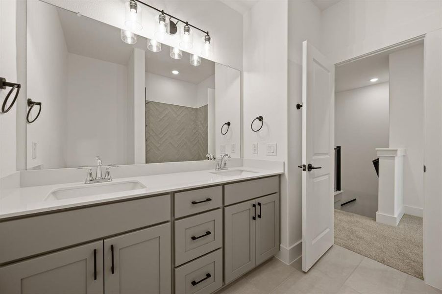 Guests will enjoy their own vanity space in this thoughtfully designed guest bath.
