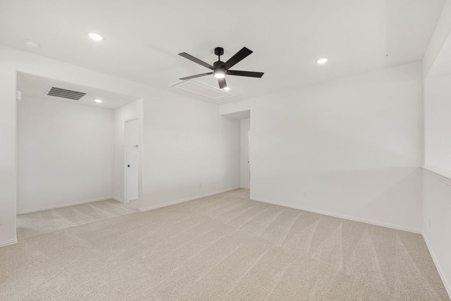 Empty bedroom with beige carpet, white walls, ceiling fan, and recessed lighting Empty bedroom with beige carpet, white walls, ceiling fan, and recessed lighting