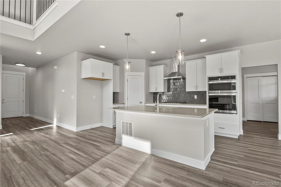 Kitchen equipped with wall oven, gas cooktop, and pantry