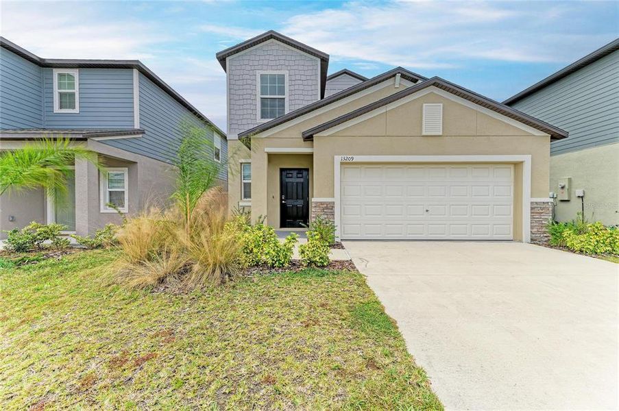 Front exterior of a new home in , Parrish, FL, highlighting curb appeal (Image 1). Front exterior of a new home in , Parrish, FL, highlighting curb appeal (Image 1).