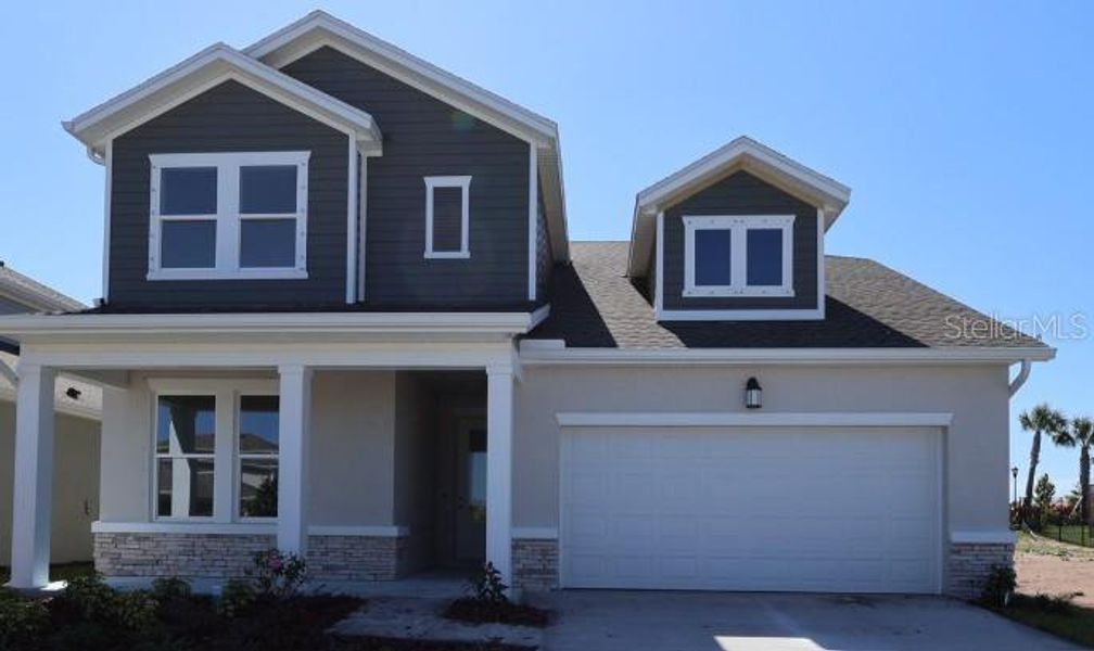 Front exterior of a new home in Waterset Classic Series, Apollo Beach, FL, highlighting curb appeal (Image 2). Front exterior of a new home in Waterset Classic Series, Apollo Beach, FL, highlighting curb appeal (Image 2).