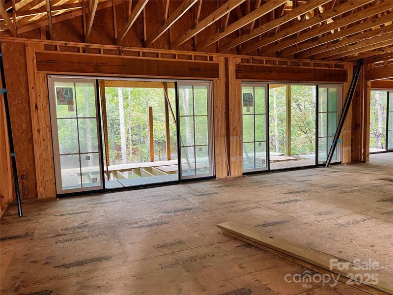 Two oversized sliders seamlessly bring the outdoors in. Two oversized sliders seamlessly bring the outdoors in.