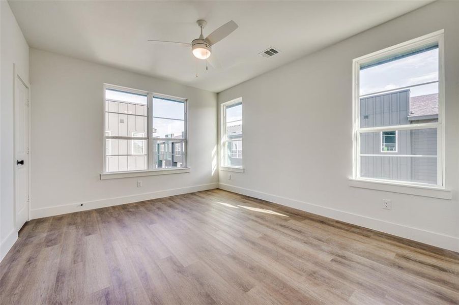 Spare room with hardwood / wood-style floors and ceiling fan