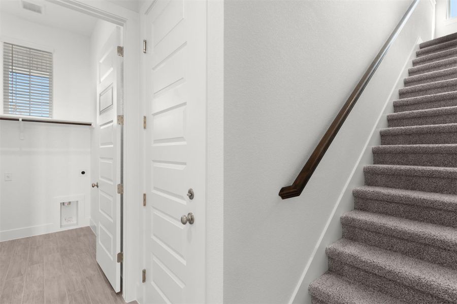 Staircase featuring wood finished floors