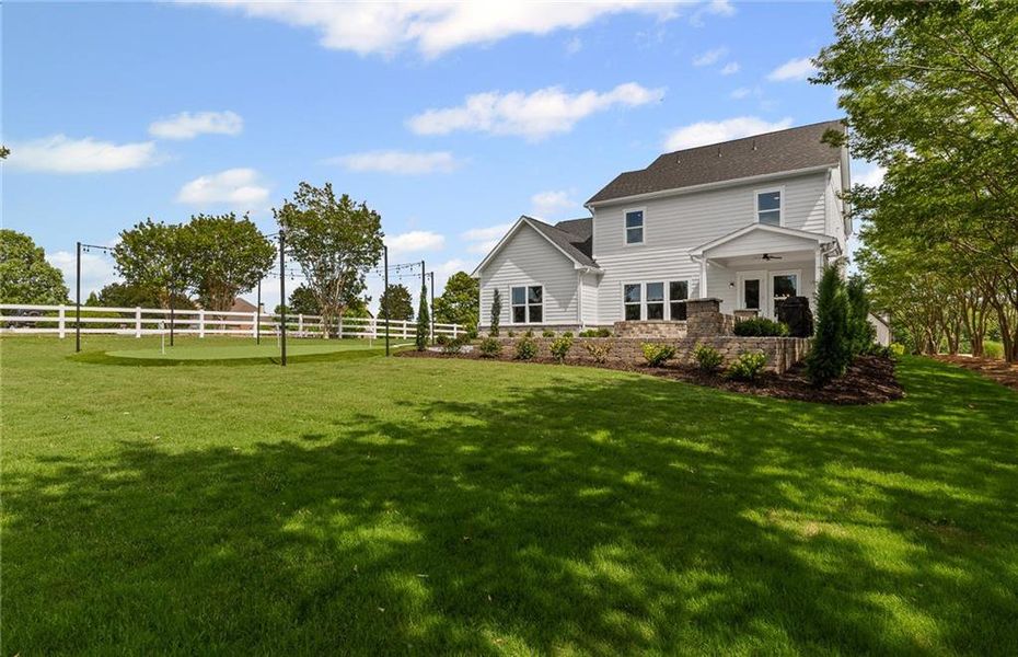Front exterior of a new home in Traditions of Braselton, Hoschton, GA, highlighting curb appeal (Image 25).