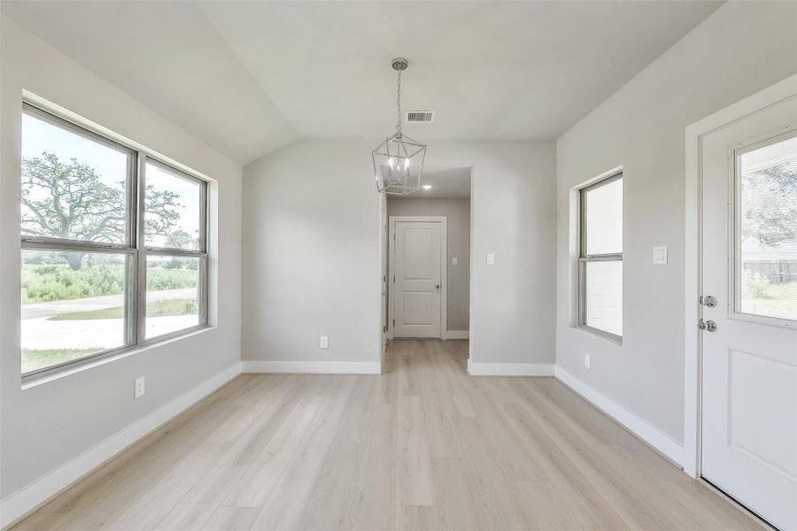 Spacious dining nook with corner lot views and easy access to the garage and laundry area for everyday convenience.