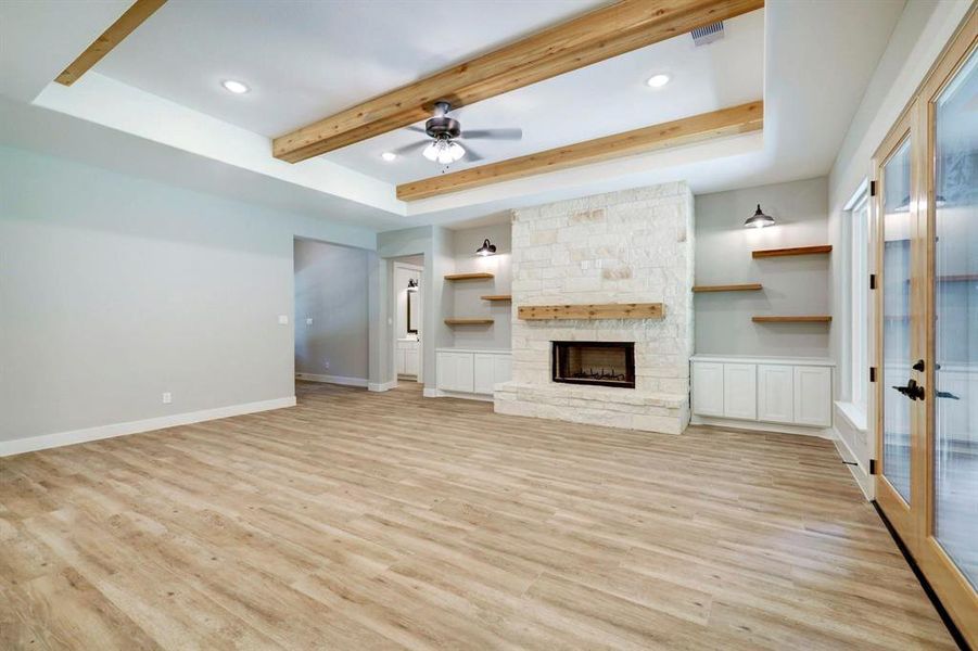 The inviting fireplace, with custom built cabinets becomes a focal point that anchors the room and invites people to gather and linger, making it a cherished feature of the living area.