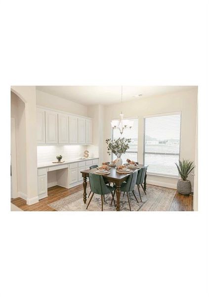 Dining area featuring a chandelier and light hardwood / wood-style floors