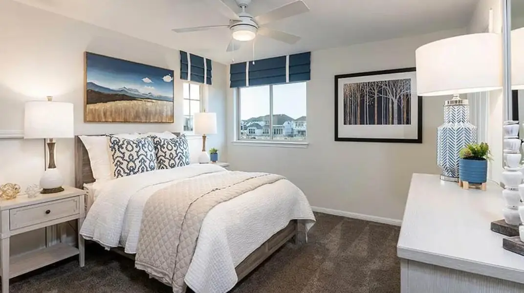 Bedroom with dark colored carpet and a ceiling fan