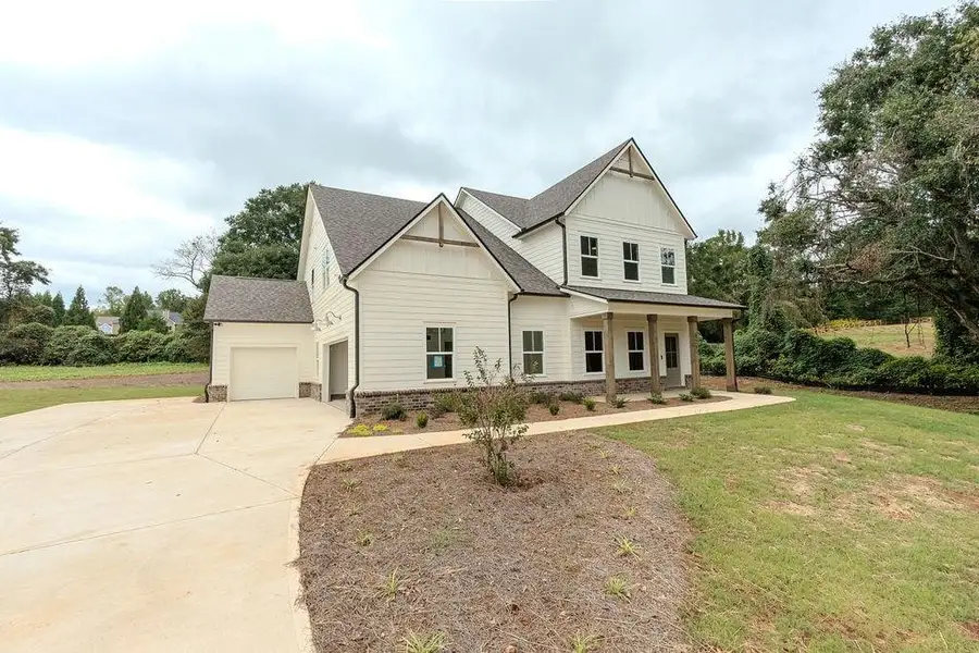 Front exterior of a new home in , Hoschton, GA, highlighting curb appeal (Image 30).