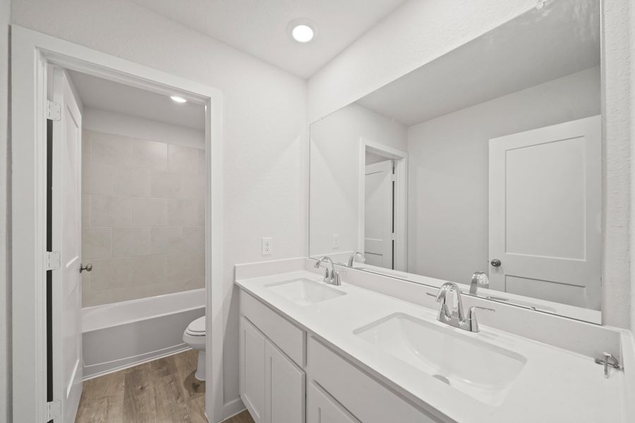 A bathroom with a sink and a shower. A bathroom with a sink and a shower.