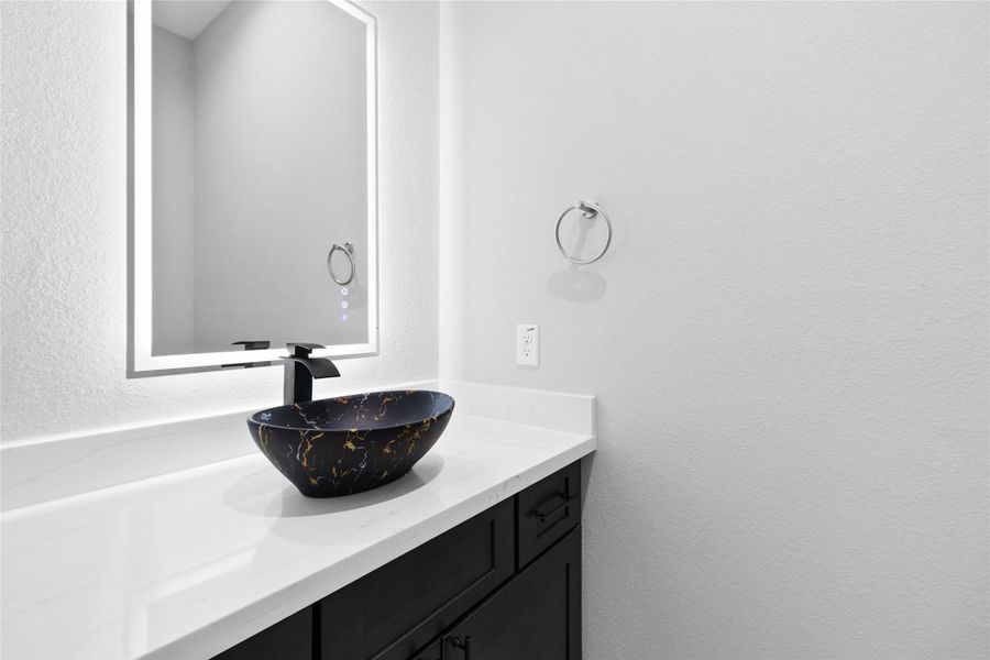 Your powder bath feels like a designer’s touch—every detail, from the glowing mirror to the deep blue vessel sink, makes even quick stops feel luxurious. Your powder bath feels like a designer’s touch—every detail, from the glowing mirror to the deep blue vessel sink, makes even quick stops feel luxurious.