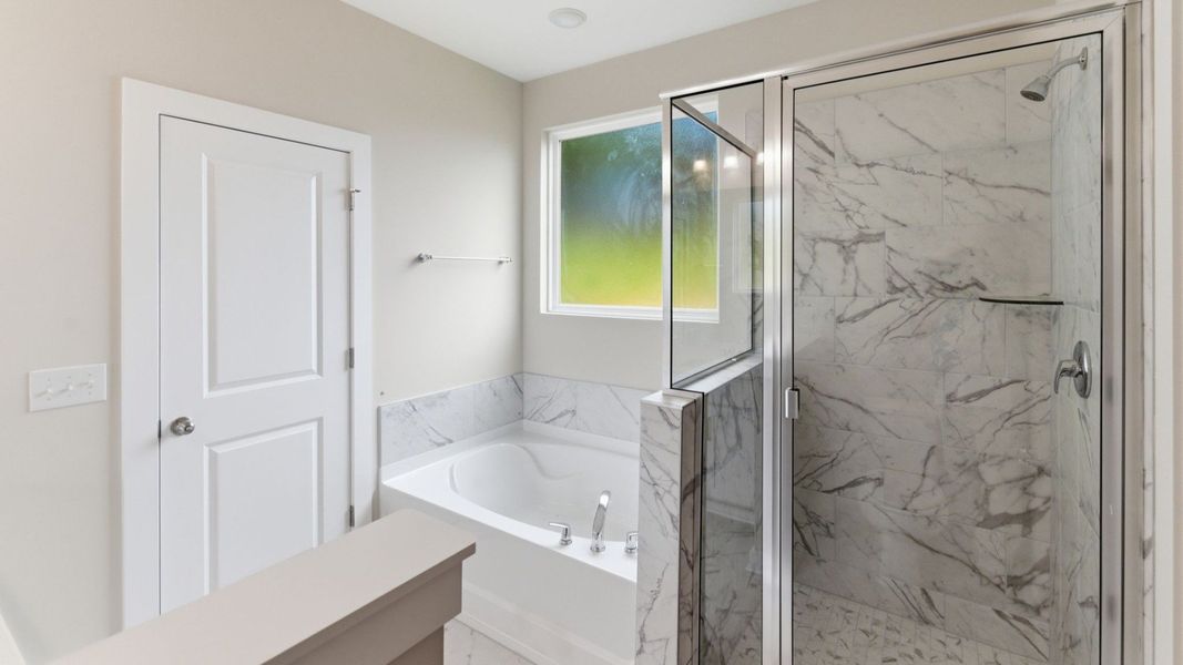 Bathroom with tub and glass enclosed shower