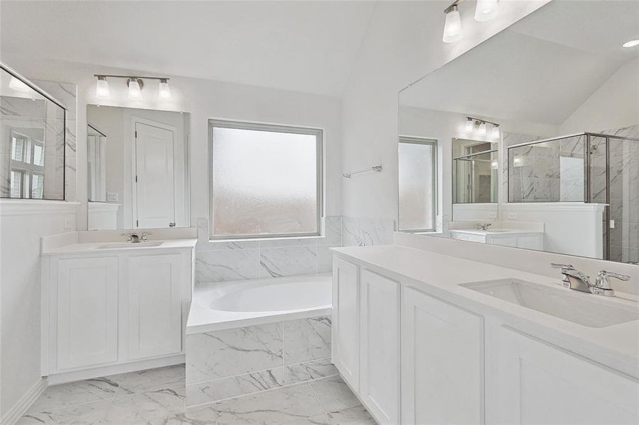 Bathroom with plus walk in shower, tile patterned flooring, vaulted ceiling, and double sink vanity