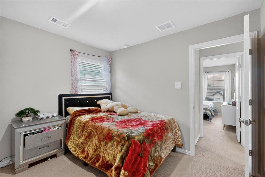 Bedroom with light colored carpet and baseboards Bedroom with light colored carpet and baseboards