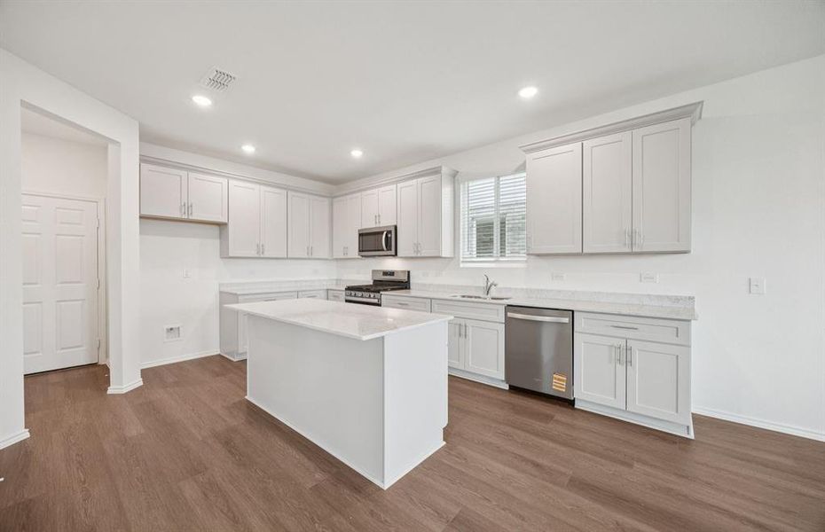 Spacious kitchen with eat-in bartop island