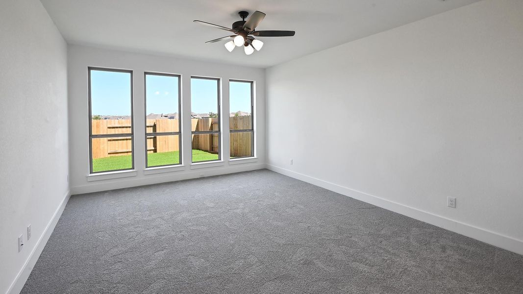 Spare room featuring carpet flooring and a ceiling fan