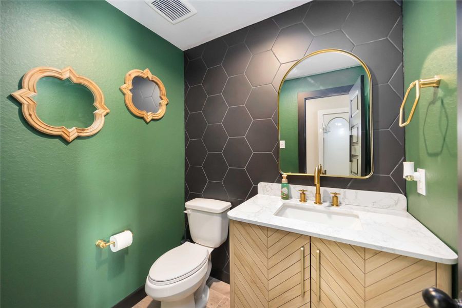 Convenient first-floor half bath with modern vanity and upgraded finishes. Convenient first-floor half bath with modern vanity and upgraded finishes.
