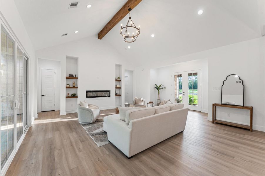 Open-concept living area with soaring cathedral ceilings, large windows for natural light, and LED recessed lighting throughout — a space where luxury meets comfort. Open-concept living area with soaring cathedral ceilings, large windows for natural light, and LED recessed lighting throughout — a space where luxury meets comfort.