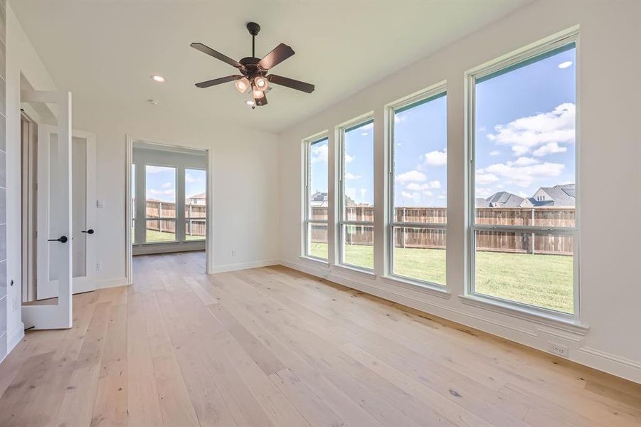 Unfurnished room featuring ceiling fan and light hardwood / wood-style floors