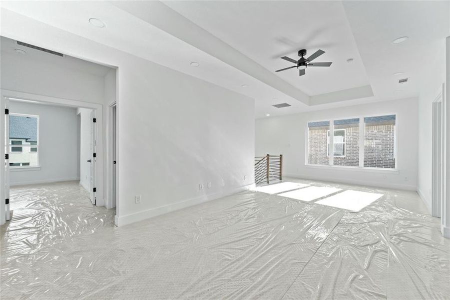 Spare room featuring ceiling fan and a tray ceiling Spare room featuring ceiling fan and a tray ceiling