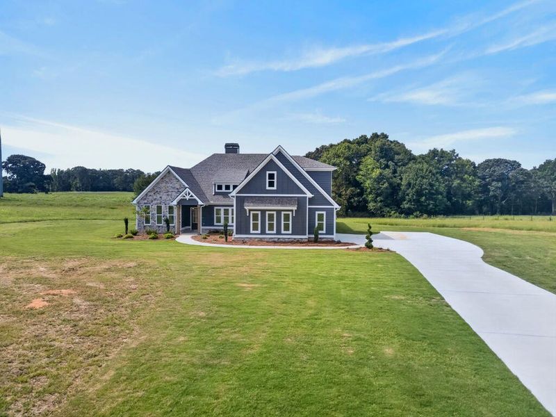 Front exterior of a new home in Veal Meadows, Roopville, GA, highlighting curb appeal (Image 32). Front exterior of a new home in Veal Meadows, Roopville, GA, highlighting curb appeal (Image 32).