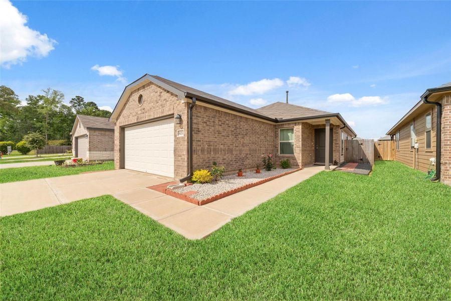 Side view showcasing the home’s clean lines and natural light, with a walkway that guides you to the entrance.