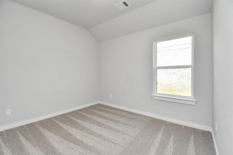 Generously sized secondary bedrooms featuring spacious closets, soft and inviting carpeting underfoot, large windows allowing plenty of natural light. Sample photo of completed home. As-built color and selections may vary.