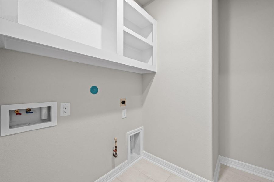 The laundry room layout is carefully planned for optimal workflow with designated areas for washing, drying, and storing.