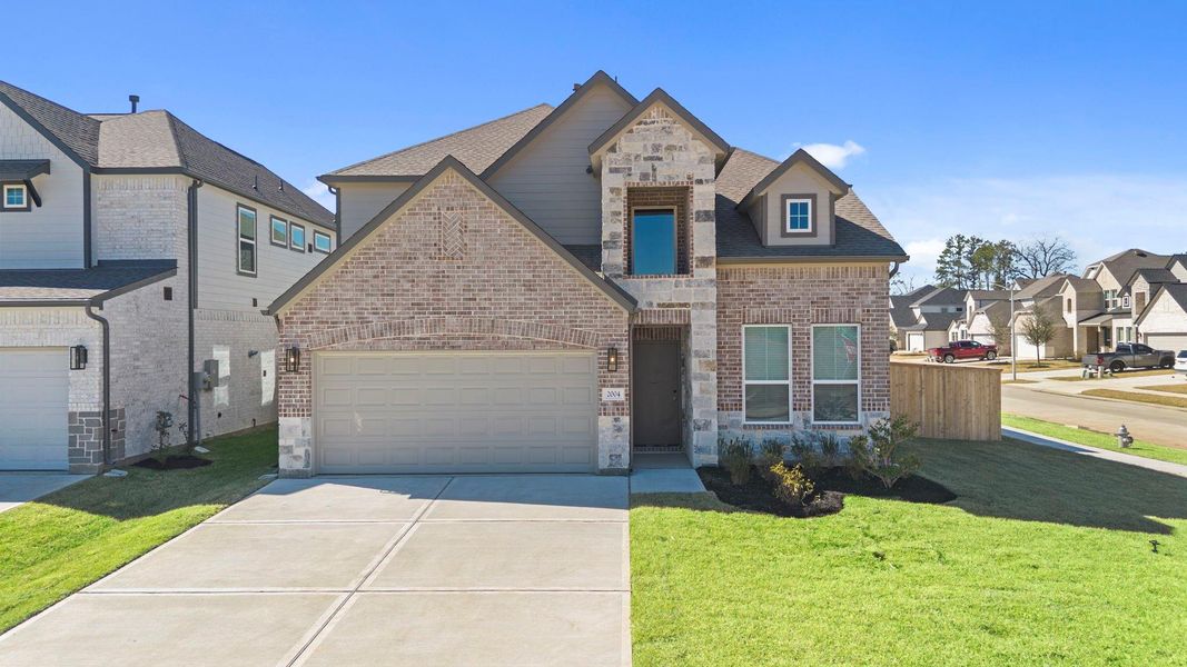 Front exterior of a new home in Barton Creek Ranch, Conroe, TX, highlighting curb appeal (Image 1). Front exterior of a new home in Barton Creek Ranch, Conroe, TX, highlighting curb appeal (Image 1).