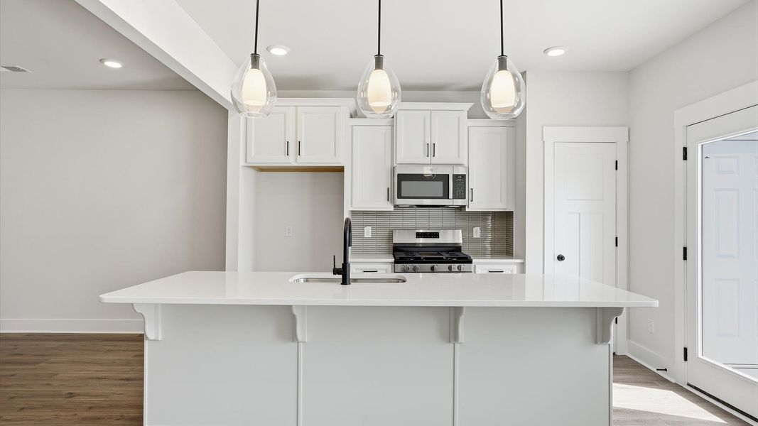 First-rate kitchen with a center island and superior cabinetry in a thoughtfully designed space at Barton Hollow First-rate kitchen with a center island and superior cabinetry in a thoughtfully designed space at Barton Hollow