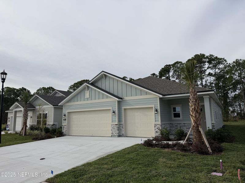 Front exterior of a new home in The Magnolia Series at Reserve East, Flagler Beach, FL, highlighting curb appeal (Image 20).