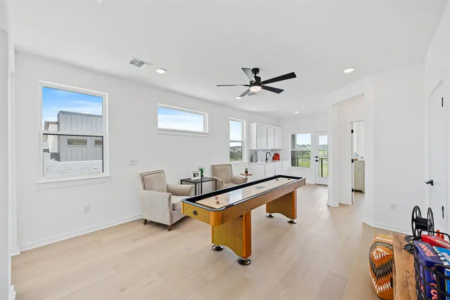 Rec or flex space with light wood-flooring, recessed lighting, french doors, and a ceiling fan