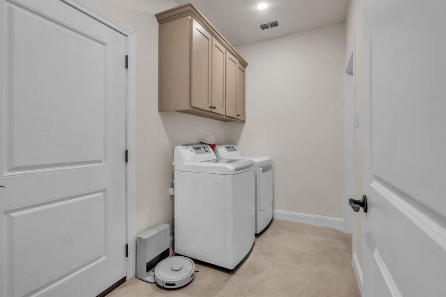 Laundry area with washing machine and clothes dryer, cabinet space, and recessed lighting Laundry area with washing machine and clothes dryer, cabinet space, and recessed lighting