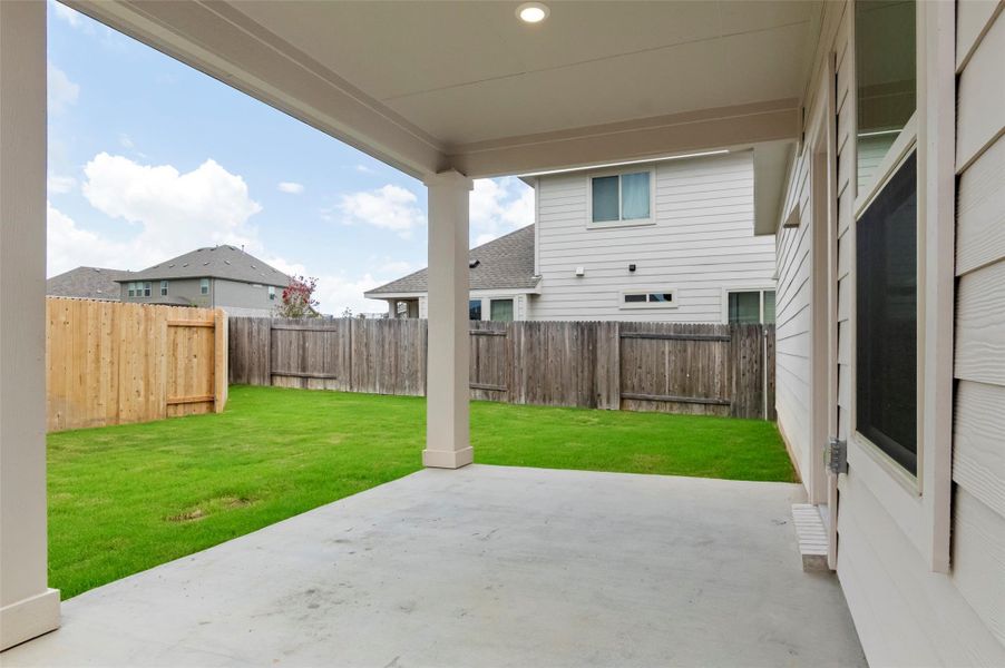 Fenced backyard with a patio area Fenced backyard with a patio area